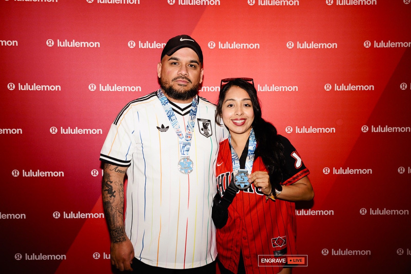 Two guests wearing their engraved finisher medals
