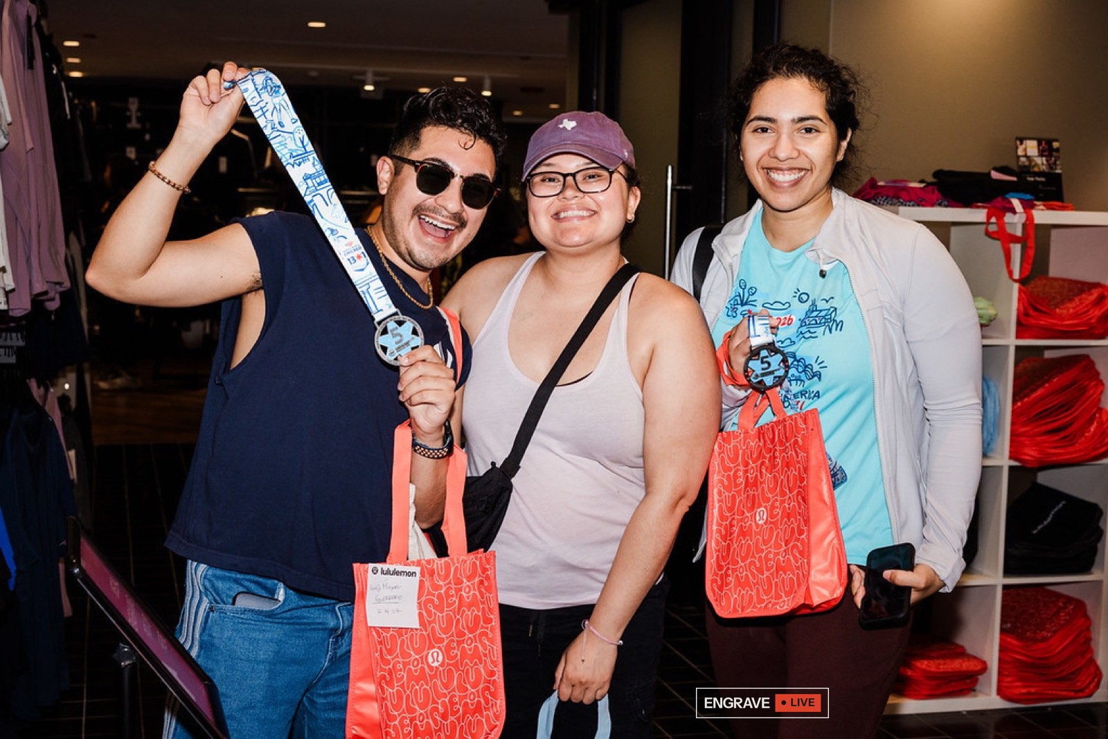 Three guests with engraved medals and event bags